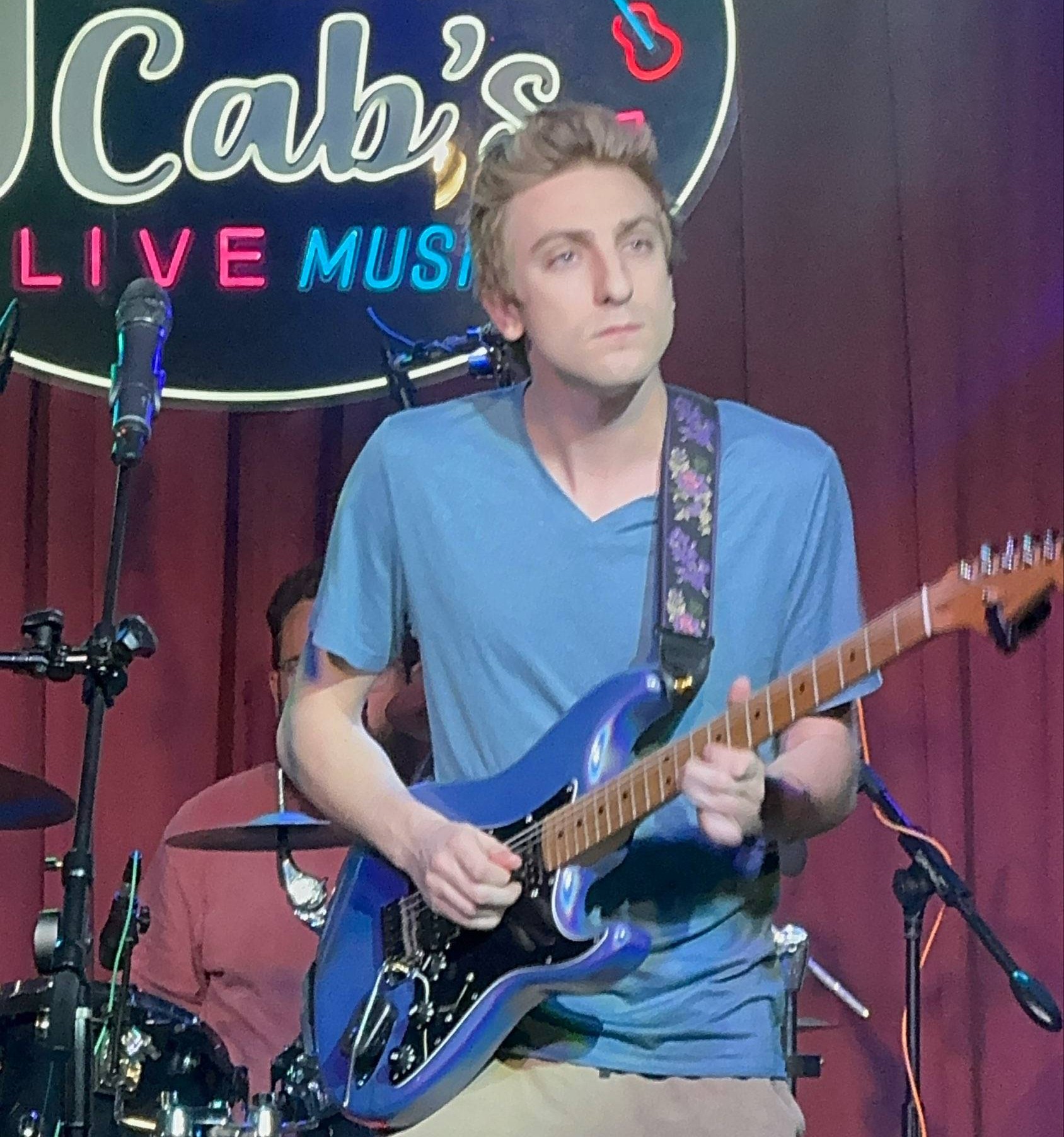 August Domanchuk playing guitar